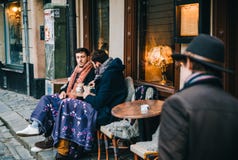 Two men drink a coffee in the outdoor cafe, Stockholm Stock Image Two men drink a coffee in the outdoor cafe, Stockholm Stock Image