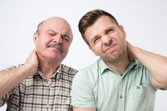 Two men father ans son suffering with neck pain royalty free stock photo Two men father ans son suffering with neck pain royalty free stock photo