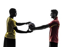 Two men soccer player giving football silhouette stock photos Two men soccer player giving football silhouette stock photos