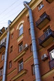 Two metal air ventilating tubes run along the facade of a brick building stock photography Two metal air ventilating tubes run along the facade of a brick building stock photography