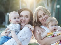 Two Mothers And Their Babies Stock Photos