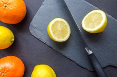 Two Orange and Three Lemons on Gray Surface Royalty Free Stock Photography Two Orange and Three Lemons on Gray Surface Royalty Free Stock Photography