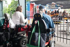 Two people on wheelchairs enjoying the outdoors concert royalty free stock image Two people on wheelchairs enjoying the outdoors concert royalty free stock image