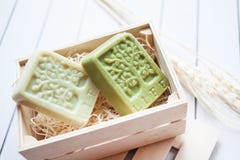 Beautiful, fragrant handmade soap in wooden box standing on a wooden background royalty free stock photography Beautiful, fragrant handmade soap in wooden box standing on a wooden background royalty free stock photography