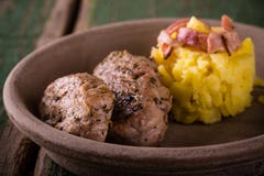 Two portions of pork tenderloin on clay plate with potatoes Royalty Free Stock Photo Two portions of pork tenderloin on clay plate with potatoes Royalty Free Stock Photo