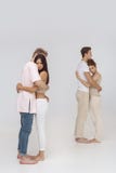 Two romantic couples in love indoors against white Royalty Free Stock Image Two romantic couples in love indoors against white Royalty Free Stock Image
