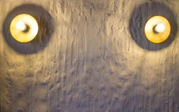 Two round gold lamp on the white stone wall with texture and shadows stock photo Two round gold lamp on the white stone wall with texture and shadows stock photo