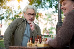 Two senior comrades sitting at chessboard royalty free stock image Two senior comrades sitting at chessboard royalty free stock image