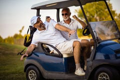Men`s having fun. Two senior man having fun in the golf car