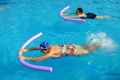 Two senior women doing swimming exercise in pool. stock image Two senior women doing swimming exercise in pool. stock image