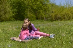 Two sisters had a picnic in a green meadow stock photo Two sisters had a picnic in a green meadow stock photo