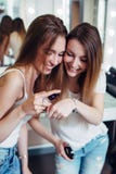 Two sisters testing foundation product cream recording a new make-up application guide for their beauty vlog royalty free stock images Two sisters testing foundation product cream recording a new make-up application guide for their beauty vlog royalty free stock images