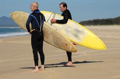 Two Surfers Looking At The Waves Royalty Free Stock Image