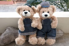 Two teddy bears on wood background