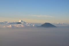 Two volcano mountains visible above the cloud around Yogyakarta, Indonesia near sunset