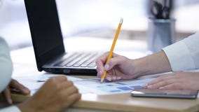 Two women making notes and discussing project, effective teamwork at office royalty free stock photos Two women making notes and discussing project, effective teamwork at office royalty free stock photos
