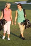 Two Women Walking Along Golf Course