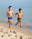 Two Young Boys Having Fun On Beach Stock Images