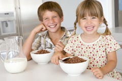 Two Young Children In Kitchen Eating Cereal Royalty Free Stock Photos Two Young Children In Kitchen Eating Cereal Royalty Free Stock Photos