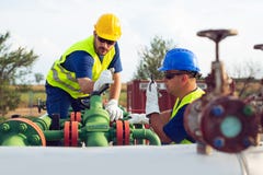 Two engineers working inside oil and gas refinery royalty free stock photo Two engineers working inside oil and gas refinery royalty free stock photo