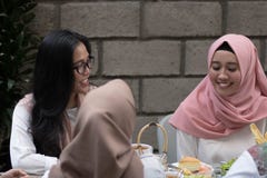 Two young muslim female having conversation while enjoying meal royalty free stock photo Two young muslim female having conversation while enjoying meal royalty free stock photo