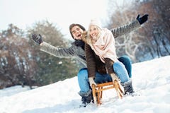 Two young people sliding on a sled stock images Two young people sliding on a sled stock images