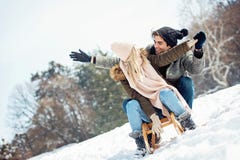 Two young people sliding on a sled stock images Two young people sliding on a sled stock images