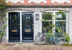 Typical house entrance with two doors and bicycle in Amsterdam Royalty Free Stock Photography Typical house entrance with two doors and bicycle in Amsterdam Royalty Free Stock Photography