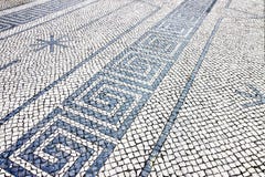 Typical portuguese floor made of small pieces of black and white stone royalty free stock photography Typical portuguese floor made of small pieces of black and white stone royalty free stock photography