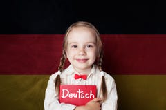 Uczyć się niemieckiego języka pojęcie z szczęśliwą dziecko dziewczyną fotografia stock Uczyć się niemieckiego języka pojęcie z szczęśliwą dziecko dziewczyną fotografia stock
