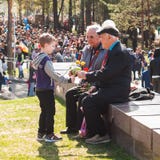 Ufa, Russia-may 09: the boy gives flowers to war veterans. victory parade.
