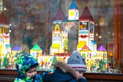 Ukraine, Lviv - December 6, 2018. Two little boys on a Lviv street looking at shop window decorated for Christmas royalty free stock photography Ukraine, Lviv - December 6, 2018. Two little boys on a Lviv street looking at shop window decorated for Christmas royalty free stock photography
