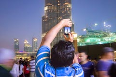 Um homem na multidão fotografa a skyline de Dubai imagens de stock royalty free Um homem na multidão fotografa a skyline de Dubai imagens de stock royalty free