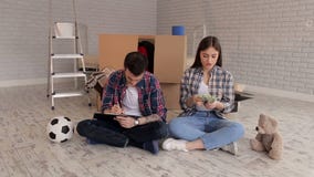 Un couple comptant l'argent et notant leurs dépenses en bloc-notes housewarming clips vidéos Un couple comptant l'argent et notant leurs dépenses en bloc-notes housewarming clips vidéos