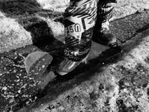 Un enfant marche en bottes par des magmas au printemps ou hiver par temps ensoleill? photographie stock Un enfant marche en bottes par des magmas au printemps ou hiver par temps ensoleill? photographie stock