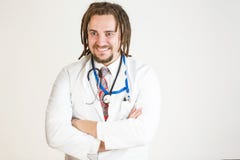 Un jeune docteur avec des dreadlocks et une barbe rit image libre de droits Un jeune docteur avec des dreadlocks et une barbe rit image libre de droits