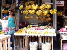 Un venditore prepara il succo di frutta nel suo supporto di frutta in un mercato in Cainta, le Filippine fotografia stock Un venditore prepara il succo di frutta nel suo supporto di frutta in un mercato in Cainta, le Filippine fotografia stock