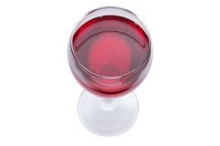 Un vidrio de vino rojo es una visión superior Bebida alcohólica en un fondo blanco Fotografía de archivo libre de regalías Un vidrio de vino rojo es una visión superior Bebida alcohólica en un fondo blanco Fotografía de archivo libre de regalías