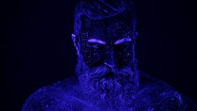 Una danza irreal de un hombre en la luz ultravioleta El hombre fuerte, muscular es separador almacen de metraje de vídeo Una danza irreal de un hombre en la luz ultravioleta El hombre fuerte, muscular es separador almacen de metraje de vídeo