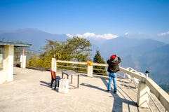 Una presa dell'uomo fotografie della montagna di Kanchenjunga dalla piazzola di eliporto di Pelling immagine stock libera da diritti Una presa dell'uomo fotografie della montagna di Kanchenjunga dalla piazzola di eliporto di Pelling immagine stock libera da diritti