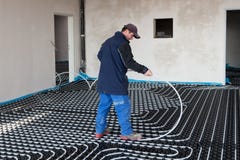 Underfloor heating and cooling. Man work on building site Underfloor heating and cooling. Man work on building site