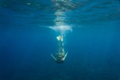 underwater photo of young woman in swimming suit and flippers diving in ocean alone royalty free stock images underwater photo of young woman in swimming suit and flippers diving in ocean alone royalty free stock images