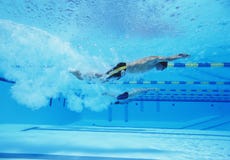 Underwater shot of three male athletes racing in swimming pool royalty free stock image Underwater shot of three male athletes racing in swimming pool royalty free stock image