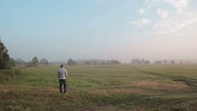 Une vue arrière d'un homme grand appréciant le temps tranquille dans la nature Il se lève ses mains sentant la liberté dans un pr banque de vidéos Une vue arrière d'un homme grand appréciant le temps tranquille dans la nature Il se lève ses mains sentant la liberté dans un pr banque de vidéos