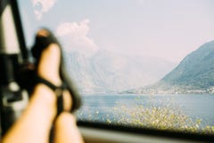 Feet in sandals on car window beautiful view royalty free stock images Feet in sandals on car window beautiful view royalty free stock images