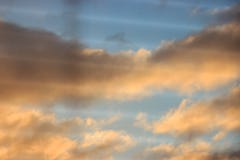Unfocused, multicolored clouds at dawn, view through the blinds. bright sky filled with sun, the morning of a new day. active royalty free stock photography Unfocused, multicolored clouds at dawn, view through the blinds. bright sky filled with sun, the morning of a new day. active royalty free stock photography