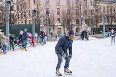 Ung man som utomhus åker skridskor på en offentlig skridskoåkningisbana i staden arkivfoton Ung man som utomhus åker skridskor på en offentlig skridskoåkningisbana i staden arkivfoton