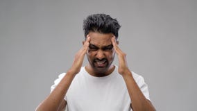 Unhappy indian man suffering from headache stock footage Unhappy indian man suffering from headache stock footage