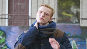 Unhappy man suffering from neck pain outdoor then smiling stock footage Unhappy man suffering from neck pain outdoor then smiling stock footage