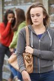 Unhappy Teenage Girl Being Gossiped About By Peers royalty free stock images Unhappy Teenage Girl Being Gossiped About By Peers royalty free stock images